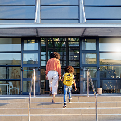 Woman and child walking into building